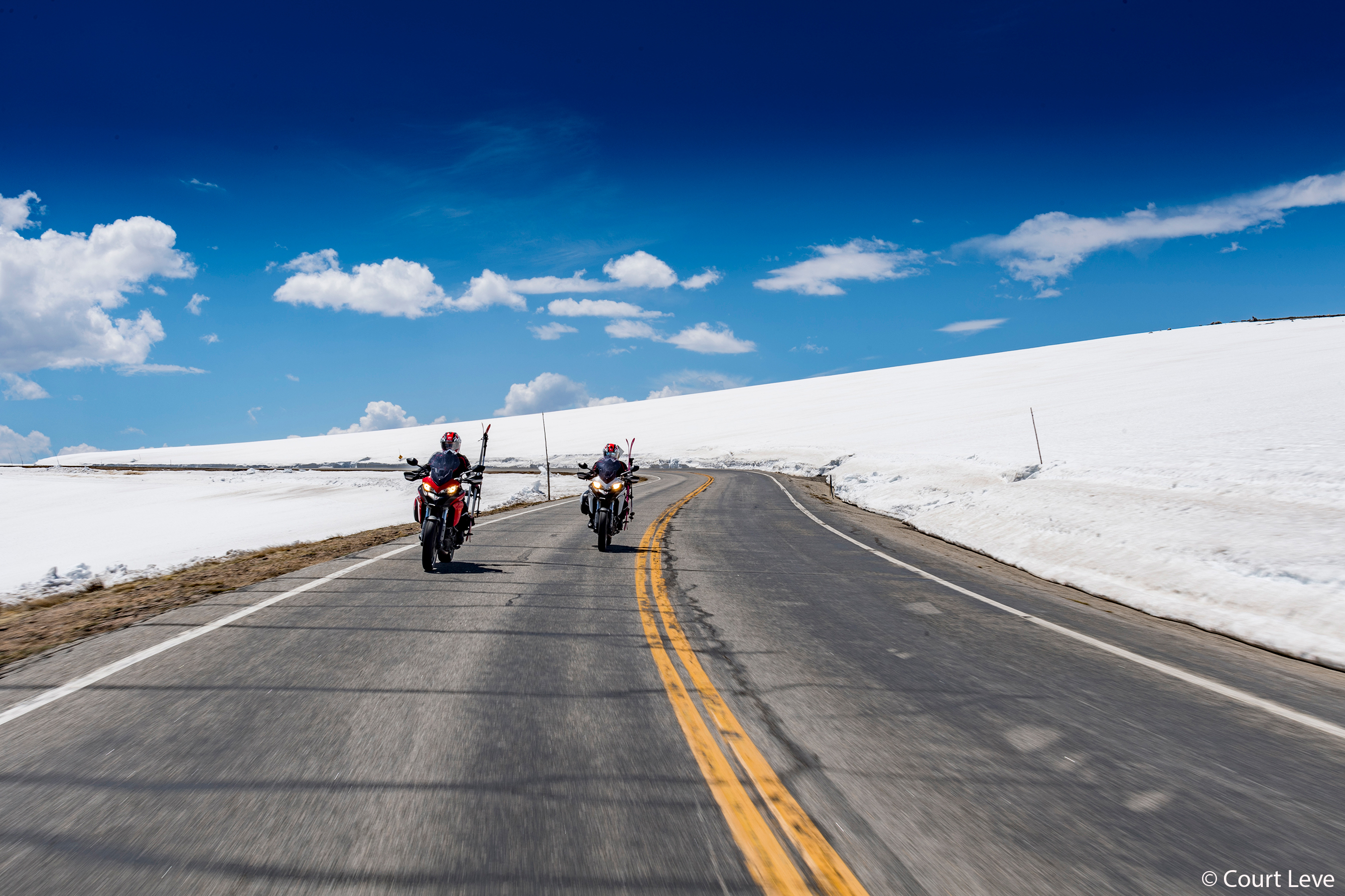 Kalen Thorien and Michael Bird Shaffer biking to ski along Beartooth Pass.